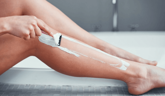 Lady Shaving her legs - hair removal technique