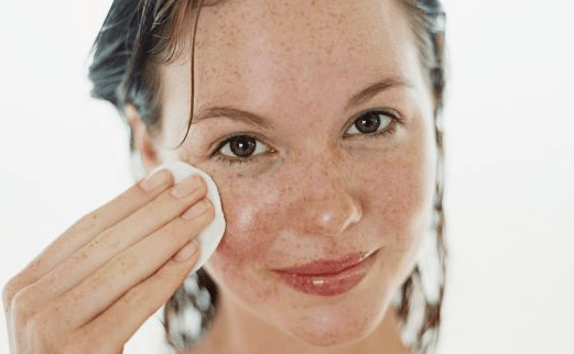 girl cleansing face